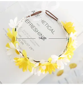 Floral headband detail showing 14cm diameter with yellow and white daisies and white ribbon.
