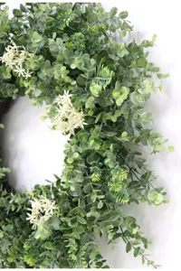 Artificial eucalyptus wreath with small white flowers for home indoor and outdoor wall decor.