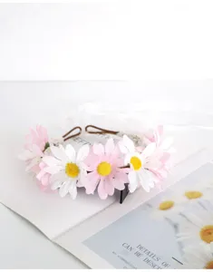Detailed close-up of a fairy forest style pink and white daisy flower headband with ribbon.