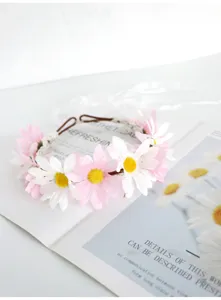 Close-up detail of fairy floral crown headband with pink white daisies and ribbons for kids.