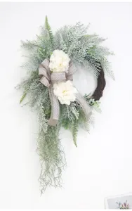 Artificial floral wreath with peonies, burlap bow and greenery for front door wall decor.
