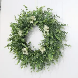 Artificial eucalyptus leaf wreath for front door decor, rustic green plant garland for home.