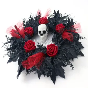 Halloween wreath decoration featuring black leaves, red roses and a spooky skull center.