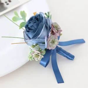 Elegant blue artificial rose boutonniere with satin ribbon for wedding groom and party guests