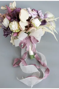 Close up view of the European retro bridal artificial rose bouquet with exquisite ribbons.