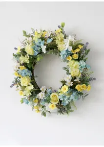 Close-up detail of artificial spring flower wreath with vibrant yellow and blue floral decor.