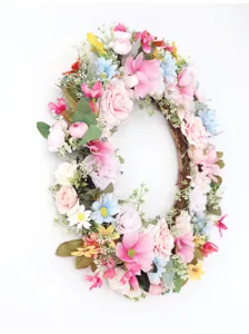 Wunderschöner künstlicher Blumenkranz mit bunten Frühlingsblüten und grünen Blättern für die Wand.