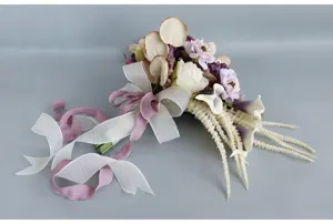 Detailed view of European vintage artificial bridal bouquet with burnt-edge roses for wedding.