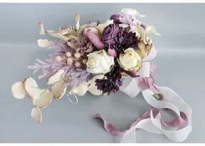 Detail shot of European vintage artificial rose bridal bouquet with ribbons for wedding.