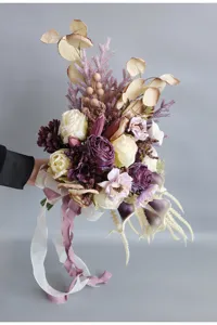 Detail view of European retro bridal hand bouquet, artificial burned-edge roses and floral art.