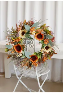 Detailed view of artificial autumn sunflower wreath for harvest festival home door decor.