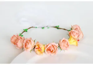 Detail shot of a fairy-style floral headband with pink roses and white ribbons for photo props.