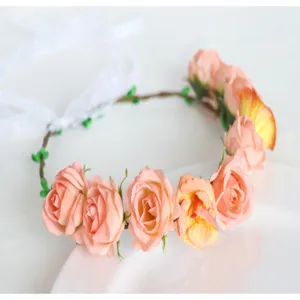 Close-up detail of simulation pink rose flower crown headband for photography props and decor.