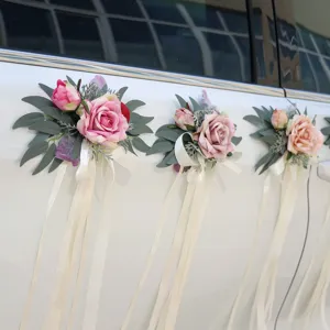 Wedding car door handle artificial rose flower decoration with white ribbons for ceremony.