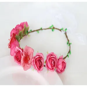 Beautiful pink artificial flower crown headband with white ribbons for photography and parties.