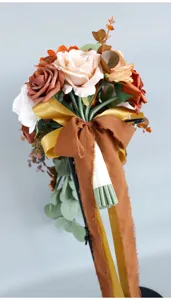 Artificial wedding bridal bouquet with autumn roses, sunflowers and silk flowers.