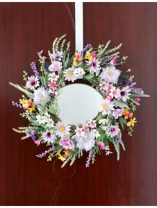 Detailansicht des farbenfrohen künstlichen Gänseblümchen-Blumenkranzes mit einem runden Spiegel.