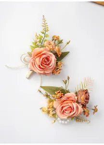 Close-up detail of artificial rose wedding corsage, elegant floral wrist flower design.