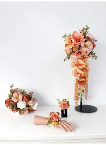 Artificial wedding flower set with cascading bridal bouquet, boutonnière, and wrist flower.
