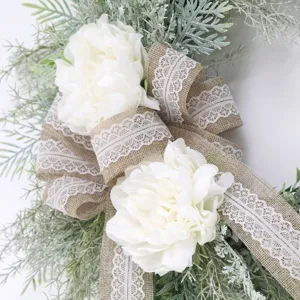 Artificial floral wreath with white peonies and burlap lace ribbon for front door wall decor.