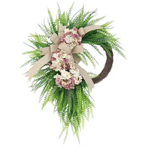 Artificial greenery teardrop wreath with burlap bow and pink flowers for front door decor.