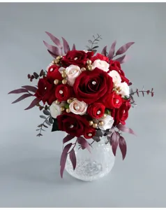 Artificial red rose wedding bridal bouquet detail view with crystal pearls and leaves.