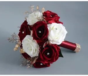 Primo piano dettaglio del bouquet da sposa artificiale con rose rosse bianche e strass scintillanti.