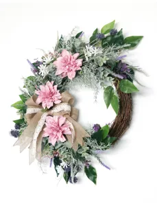 Detailed view of the artificial dahlia floral wreath with burlap bow and greenery.