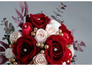 Artificial bridal rose bouquet with crystal pins and gold berries for wedding party decor.