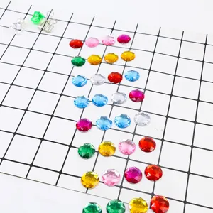 Detailed close-up view of colorful round acrylic rhinestone stickers displayed neatly on grid paper.