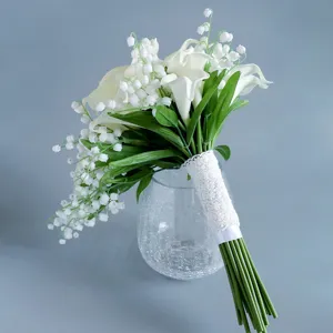 Artificial bridal bouquet featuring white calla lilies and lily of the valley with lace handle.