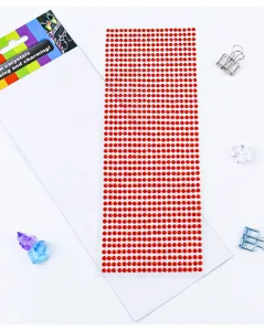 Detailed close-up of a red rhinestone sticker sheet with shiny acrylic crystals for crafts.