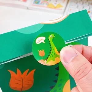 Borsa regalo di carta verde con simpatico adesivo dinosauro cartone animato per feste