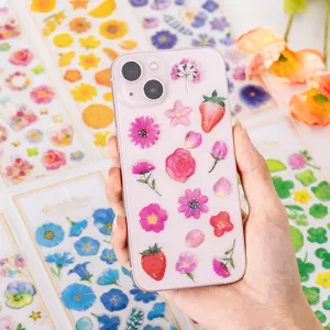 Adesivi trasparenti in resina epossidica con fiori e fragole per cover telefono e diario.