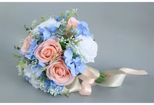 Elegant artificial bridal bouquet with pink roses and blue hydrangeas for wedding decor.