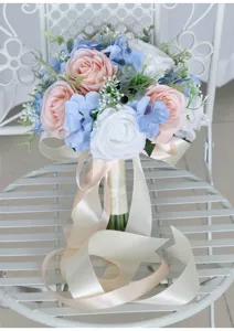 Detailed view of artificial bridal bouquet featuring pink, blue, and white roses with satin ribbons.