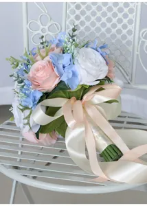 Detailed view of artificial wedding bridal bouquet with pink and blue roses for photography props.