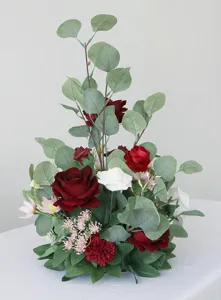 Künstliche Hochzeitsblumengestaltung Detail, rote und weiße Rosen mit Eukalyptusblättern.