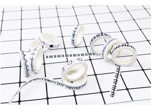 Close-up detail of black and white washi tape rolls featuring cute patterns for journal DIY.