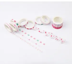 Detailed view of decorative washi tape rolls featuring cute pink floral and gift patterns.