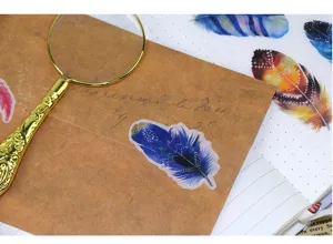 Close-up detail of colorful feather washi stickers for journaling and diary decoration.