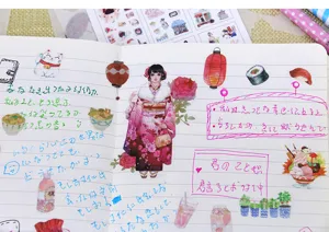 Detail shot of Japanese style washi stickers journal spread with cute girls and food.