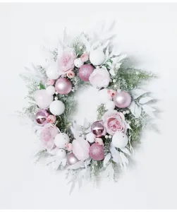 Detailed view of the pink and white Christmas floral wreath with delicate rose and ball decor.
