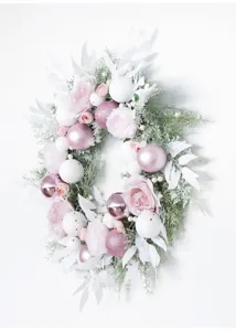 Close-up detail of the pink Christmas wreath with decorative roses and shiny baubles.
