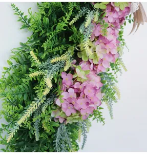 Artificial hydrangea flower hanging detail, pink floral decor with green fern leaves.