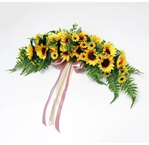 Artificial sunflower garland detail, silk floral hanging decor with green fern leaves.