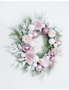 Exquisite details of pink Christmas wreath with roses and shiny balls for wedding and home decor.
