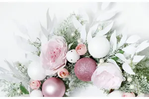 Detail view of pink Christmas wreath with baubles and peonies for wedding and home decoration.
