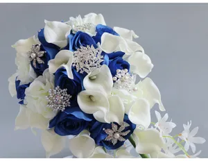 Close-up detail of blue and white wedding bridal bouquet featuring calla lilies and rhinestones.
