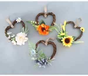 Détail de couronne cœur en fleurs artificielles avec divers motifs floraux colorés pour décoration murale.